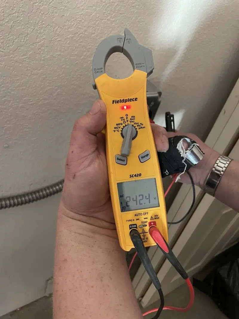 Voltage testing with clamp meter during Recessed Lighting Installation in Beverly